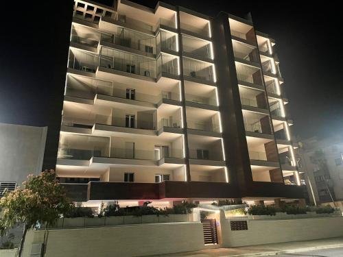 a tall apartment building at night with its lights on at La Titina Sangi in Bari