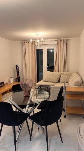 a living room with a glass table and chairs at comfy residence in Moffat