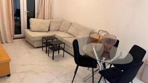 a living room with a couch and a glass table at comfy residence in Moffat
