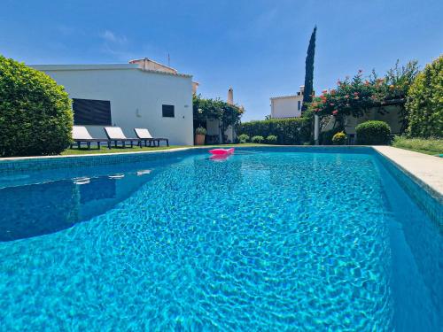 a swimming pool with a pink object in the water at Villa Vale de Ursa - 16 - BY BEDZY in Sesmarias