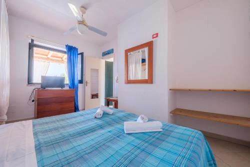 a bedroom with a bed with two towels on it at Jerà Suite Vista Mare 19 in Lipari