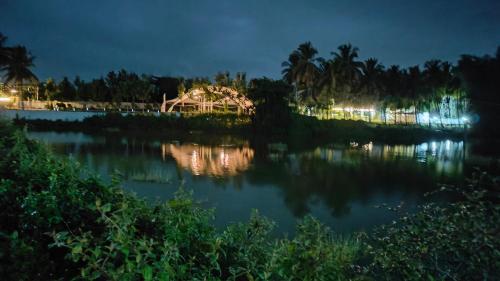 a view of a lake at night at Encanto Farmstay in Mysore