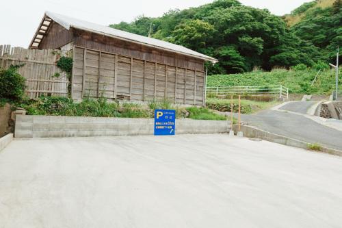a parking lot with a parking sign in front of a building at 野波一棟貸古民家 