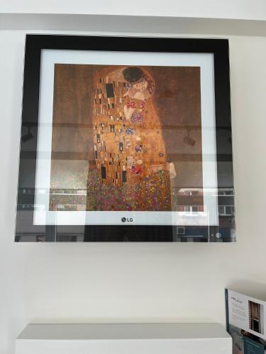 a television screen with a picture of a woman at Business Accommodation 'Eclectic Living' Nomad in Geel