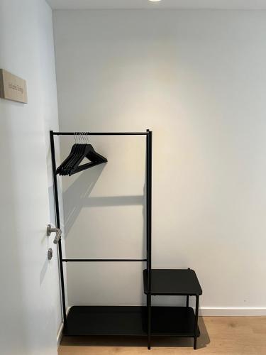 a closet with a black chair in a white wall at Business Accommodation 'Eclectic Living' Nomad in Geel