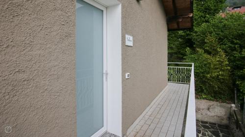 a glass door on the side of a building at Hotel Corte Santa Libera in San Fedele Intelvi