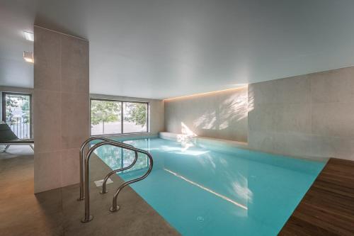 a swimming pool in a room with a staircase in it at GuestReady - Splendid Retreat in Porto in Porto