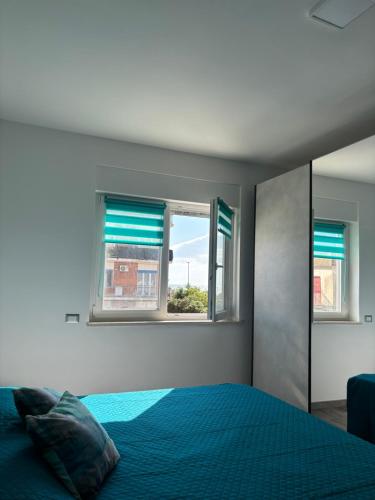 a bedroom with a bed and a window at Torvajanica Antonella in Torvaianica