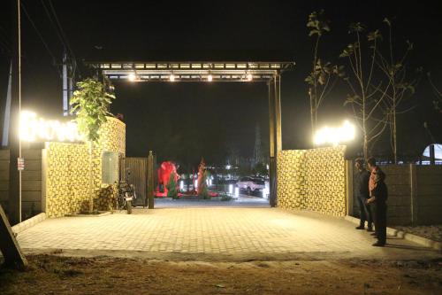 a group of people standing on a stage at night at Encanto Farmstay in Mysore