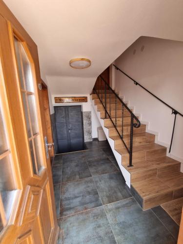 a staircase in a house with a black door at Vinný sklep u Osičky in Prušánky