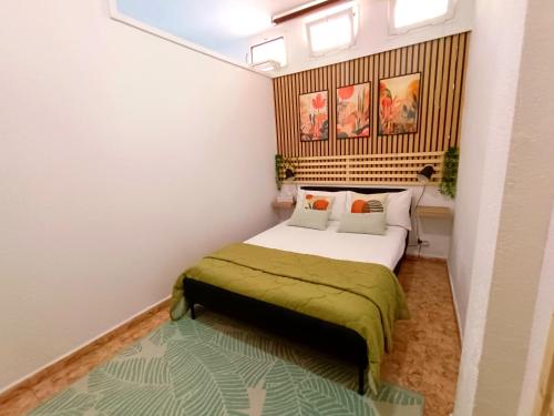 a bedroom with a bed with a green blanket at Bellavista Basement in Costa Del Silencio
