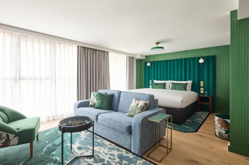 a hotel room with a bed and a couch at Hotel Indigo London Clerkenwell by IHG in London