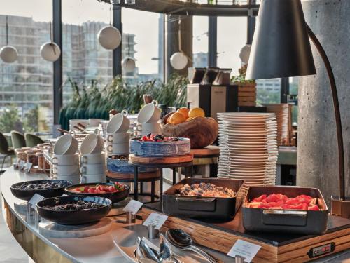 a buffet of food on a table in a restaurant at Crowne Plaza - Warsaw - The HUB by IHG in Warsaw