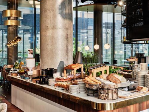 a bakery with bread and pastries on a counter at Crowne Plaza - Warsaw - The HUB by IHG in Warsaw