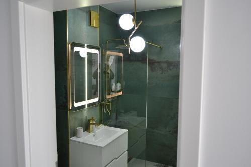 a bathroom with a sink and a mirror at Apartament POK in Constanţa