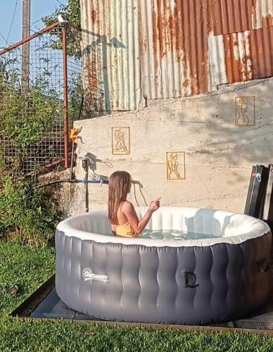 a little girl sitting in a round bath tub at Romoa - Gerês & Cabreira in Vieira do Minho