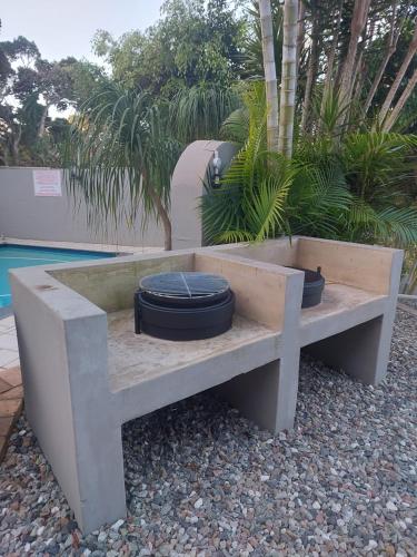a concrete bench with two tires sitting on it at Fairway Guest Lodge in Margate