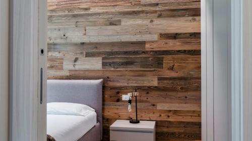 a bedroom with a reclaimed wood accent wall at Olgas Chalet in Vione