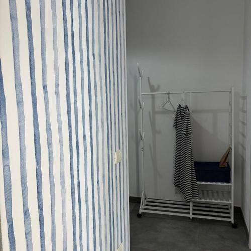 a room with a shower curtain and a dress at Maestrale in Portoscuso
