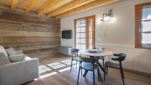 a living room with a table and chairs and a couch at Silias Home in Vione