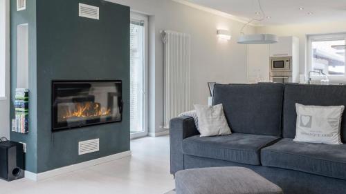 a living room with a couch and a fireplace at Snowhite in Incudine
