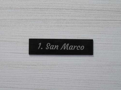 a sign that says san marco on a wooden wall at Casa Villaggio Laguna in Venice