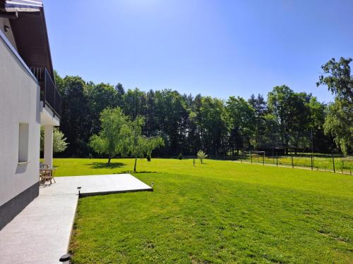 a large grassy yard next to a building at Zelena harmonija in Moravske Toplice