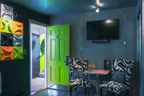 a room with a green door and a table and chairs at The Roxbury in Roxbury