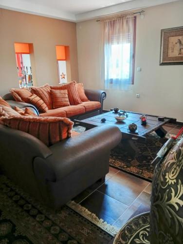 a living room with couches and a coffee table at Rural hοuse in Kastrítsa