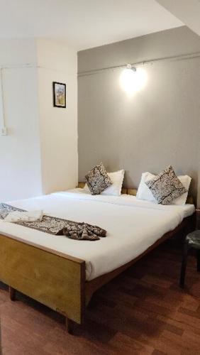 a bedroom with a large bed in a room at Hotel Sakura Mountain view Near Darjeeling Toy Train Station in Darjeeling