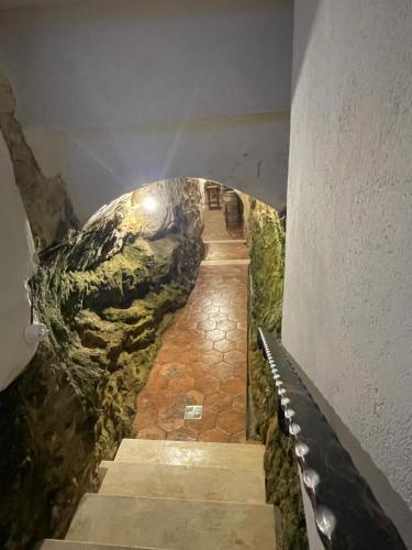 a tunnel in a building with a stairway at Mandrire in Usini