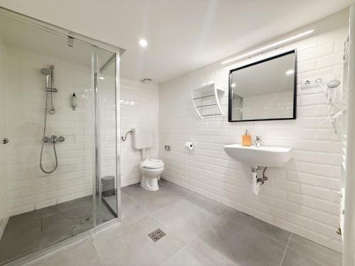 a bathroom with a toilet and a sink and a shower at Chesscom Guesthouse in Budapest