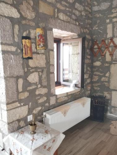 a room with a stone wall with a window and a table at The stone Mansion of 1887 