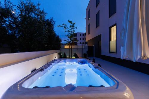 a jacuzzi tub on the side of a building at Latitude 44 Apartment in Zadar