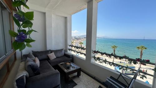 a living room with a couch and a view of the beach at Star beach in M'diq