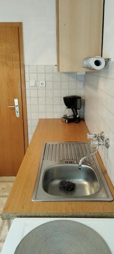 a kitchen counter with a sink in a kitchen at König in Korswandt