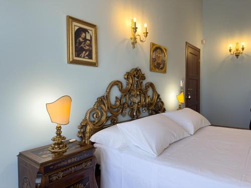 a bedroom with a bed and a table with a lamp at Relais Casale Corvo in Guglionesi