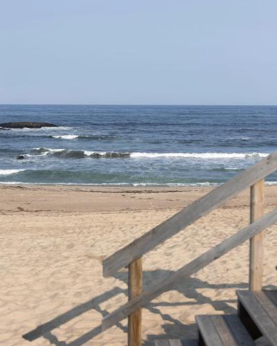 a wooden fence on a beach with the ocean at Vista Atlântica-Vila do Conde in Vila do Conde