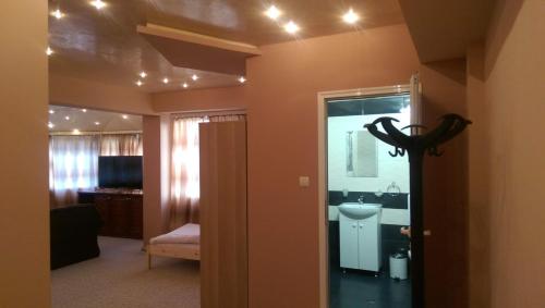 a room with a bathroom with a sink and a mirror at Стаи за гости Деметра in Sofia