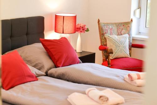 a bedroom with two beds and a lamp and a chair at Apartment Passau D, Zentral, Cozy, Parking Place in Passau