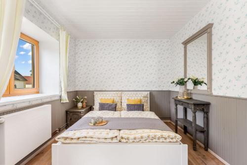 a bedroom with two beds and a window at Chalupa U Kubců in Hrubá Skála