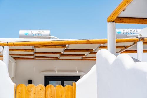 a house with a wooden fence and a ladder at Electra Suites & Spa in Perivolos