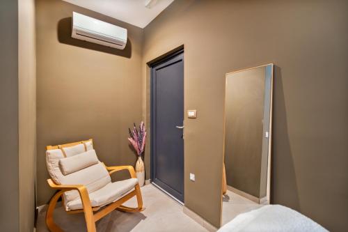 a room with a chair and a mirror at Electra Suites & Spa in Perivolos