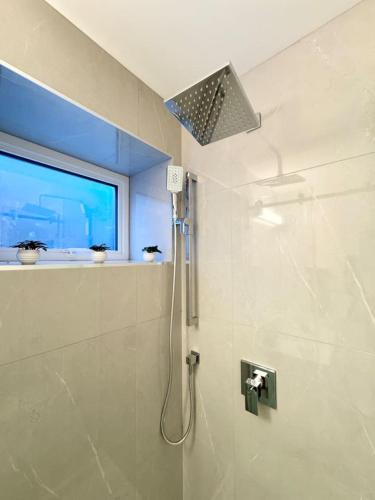 a bathroom with a shower with a shower head at Perfect Vancouver Travel Hub for Couples or Family in Vancouver