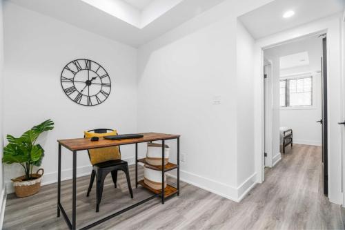 an office with a desk and a clock on a wall at RentX Cozy Downtown London Parking WiFi in London