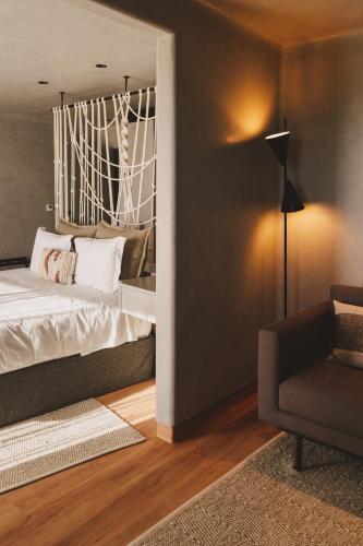 a bedroom with a bed and a chair at Santa Cruz - Movement & Nature House in Santa Cruz