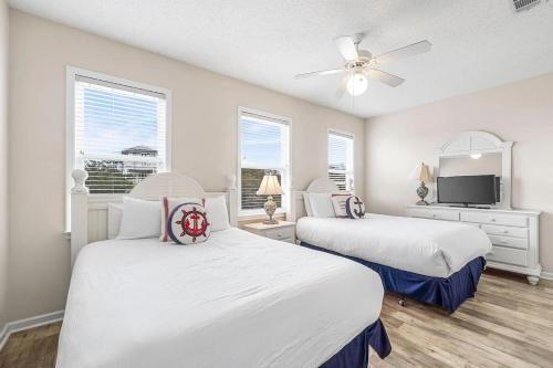 a bedroom with two beds and a ceiling fan at Barefoot Breeze,Steps To The Beach ,Pool ,Sleeps 13, Seacrest in Seacrest
