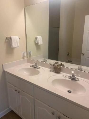 a bathroom with two sinks and a large mirror at Barefoot Breeze,Steps To The Beach ,Pool ,Sleeps 13, Seacrest in Seacrest