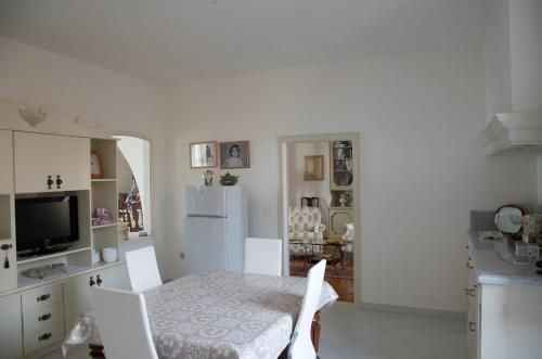 a kitchen with a table and chairs and a refrigerator at Sea view apartment, 3 bedrooms, large living room in Piombino