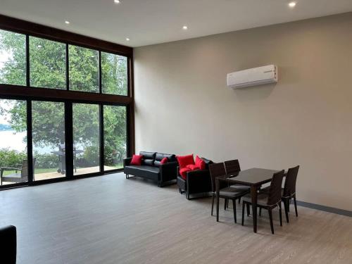 a living room with a couch and a table and chairs at 3-bedroom Lakefront Villa #3 in Lakefield